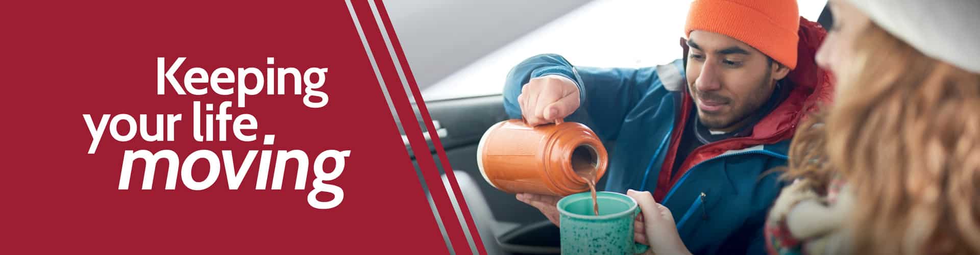 Couple sharing hot drink in car